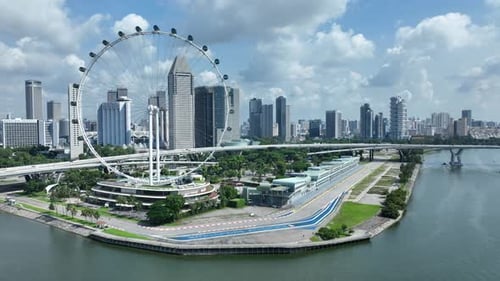 Aerial drone shot of Singapore Flyer Eye by Formula 1 One track, Marina Promenade Singapore and city