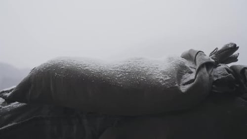 The closeup view of war trenches sandbags with snowfall from ww1 history.