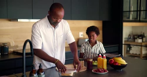 Child, father and packing school lunch in home for morning routine, healthy nutrition