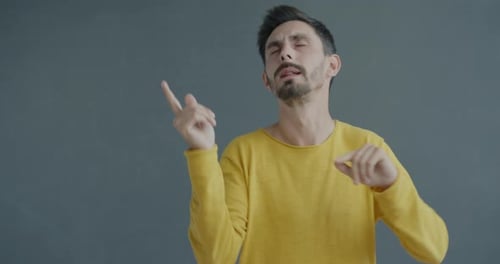 Man Dancing Happily in Yellow Shirt