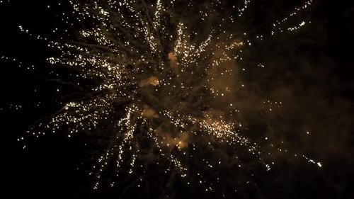 Colorful fireworks exploding in the dark sky at the night. Celebration. Camera moves a bit.