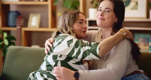 Hug, happy and face of women on sofa for bonding, loving relationship and relax together in home
