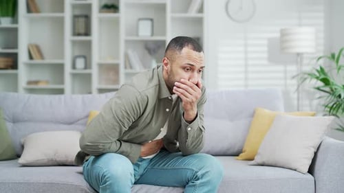 Man Suffering with Nausea and Stomach Pain at Home