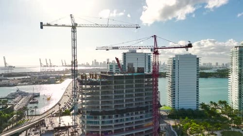 Tower Lifting Cranes at High Residential Apartment Building Construction Site Real Estate