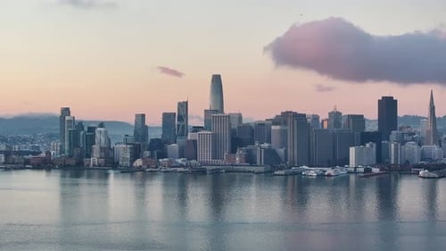 Aerial push in to San Francisco Skyline and Bay at sunrise.