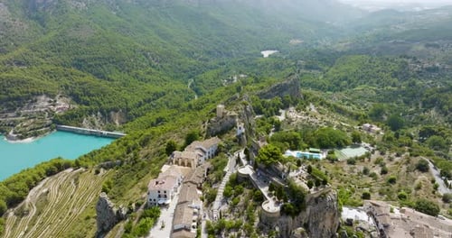 Guadalest Medieval Castle Sits On Mountain Top Overlooking Lush Forests And Lakes Drone Shot