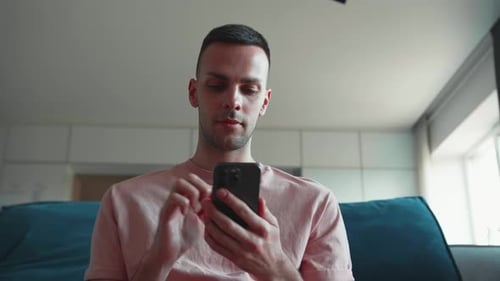 Young Adult Using Mobile Phone Indoors