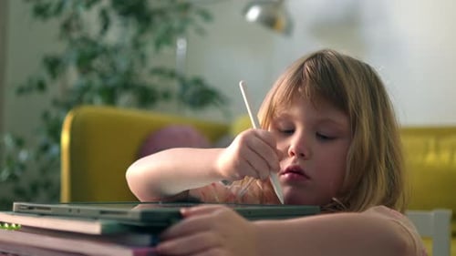 Girl Drawing on Tablet with Digital Pen Indoors