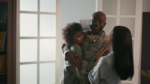 Soldier Returns Home and Embraces Family