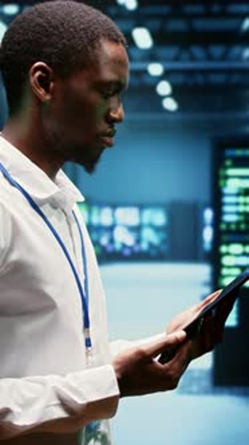 Man With Tablet in Modern Data Center