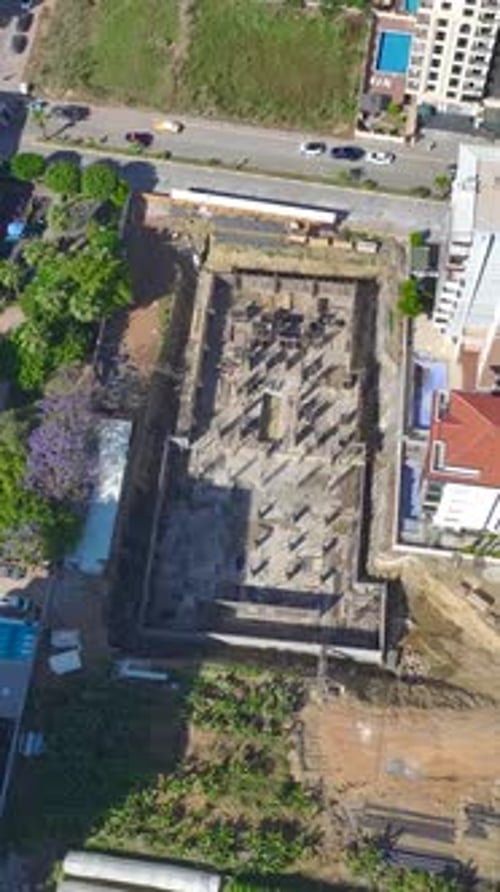 Vertical Video Active Construction Site Captures Workers Laying Bricks and Building Walls with