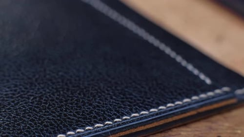 Close-up View of Black Leather with White Stitching