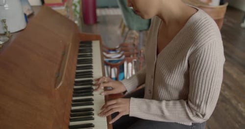 Young Adult Woman Plays Piano