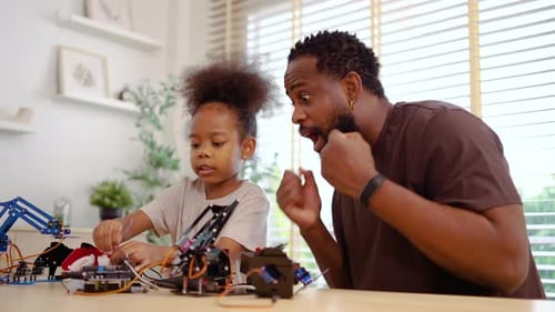Child and Adult Assemble Robotic Arm at Home