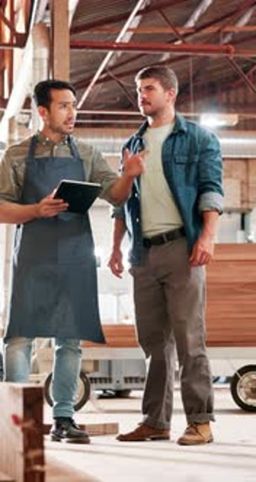 Men, carpenter and tablet at warehouse, talk and point for choice with order for construction