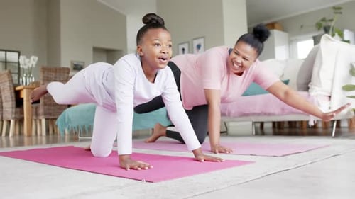 Child and Adult Doing Yoga in Living Room