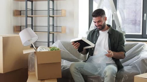 Moving, People and Real Estate Concept - Happy Smiling Man with Boxes