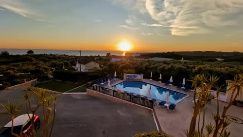 View of the pool and sunset from a hotel room