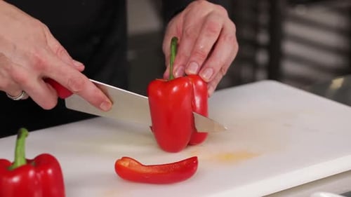 Adult Cutting Red Pepper on Cutting Board