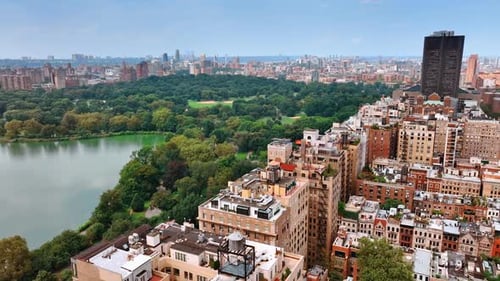 Cityscape of New York on sunny clear day. Beautiful green Central Park scenery from the top.
