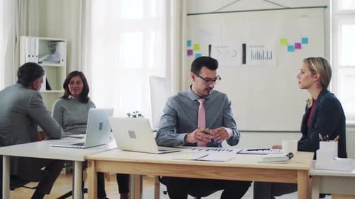 Diverse team collaborating on laptop in modern office space
