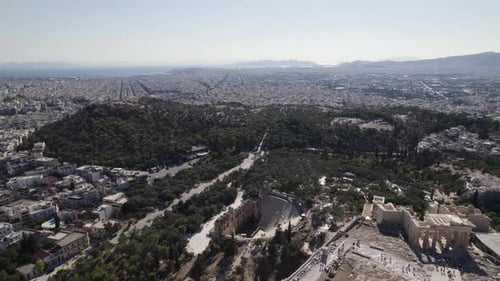 Drone flying backward revealing Famous Acropolis of Athens, Ancient momument on Hilltop, Greece