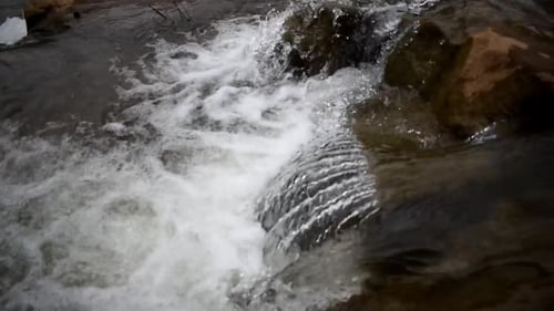 Rapidly Flowing Streams On Rocky River During Daytime. - High Angle Shot