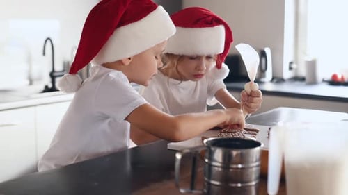 Festive Children Decorating Christmas Gingerbread Cookies at Home