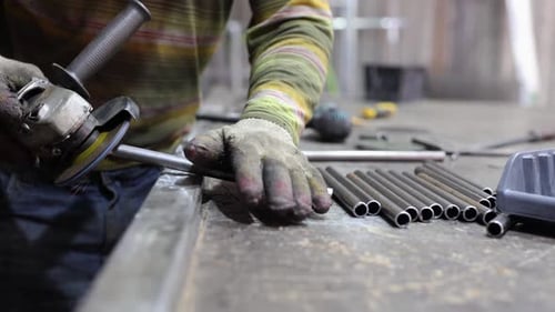 Metalworking Workshop The Master Grinds the Metal with a Grinding Machine Sparks