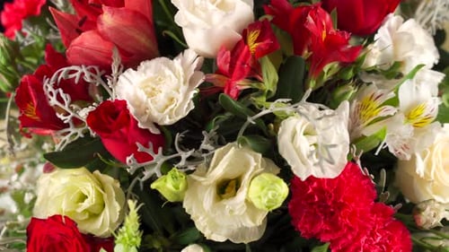Floral arrangement close up macro shot red and white roses and lily spinning