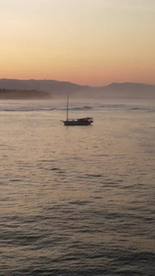 Small Sailing Boat in the Sea Near the Coast