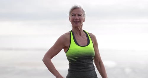 Senior woman checking activity tracker on a run