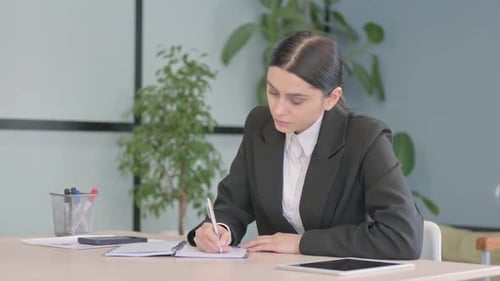 Young Businesswoman Writing Letter at Work, Paperwork