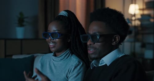 Couple Wearing 3D Glasses Watching Movie at Home