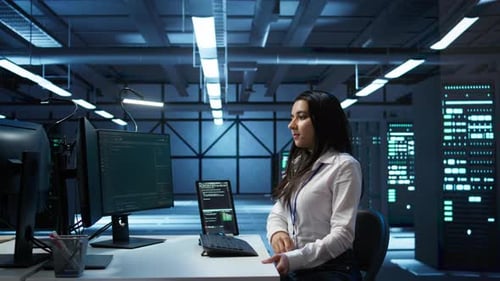 Engineer in Data Center Sitting Down at Desk Installing Software