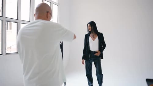 Professional Photographer Taking Pictures of Fashion Model in Studio