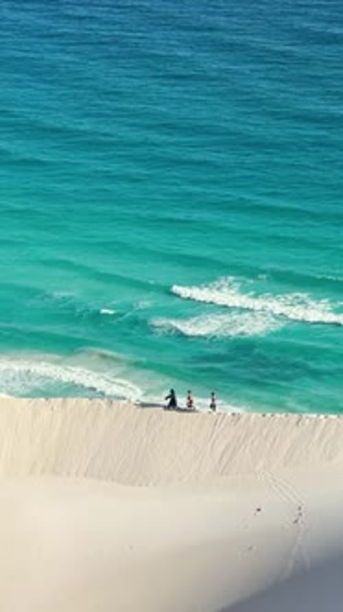 Enjoying a Serene Beach Walk Along the Beautiful Turquoise Waters of the Ocean Shoreline