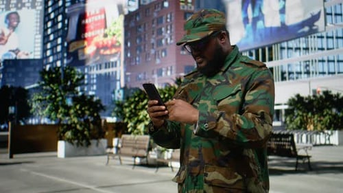 Man Looking at Phone and Celebrating in City