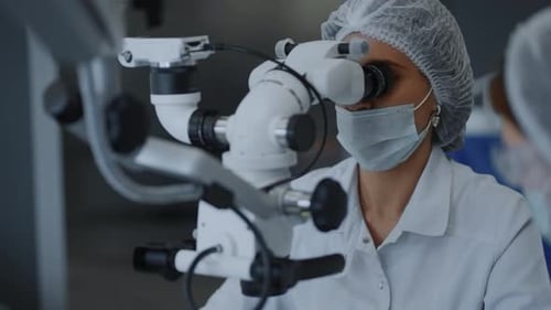 Medical Professional Using Microscope in a Hospital Setting