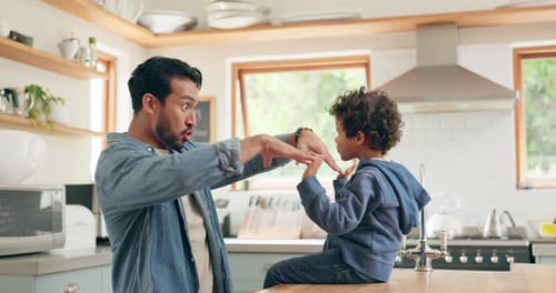 Dad and Son Playfully Bonding in Kitchen
