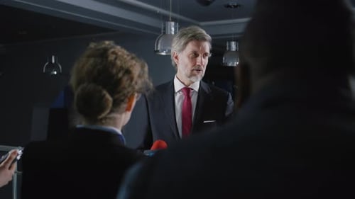 Man Giving Corporate Speech Surrounded by Media