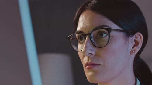 Female IT Engineer Coding at Night