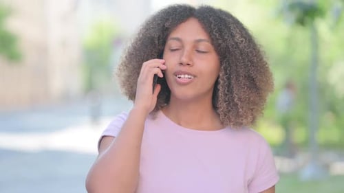 Young Adult Woman Talking on Smartphone Outdoors