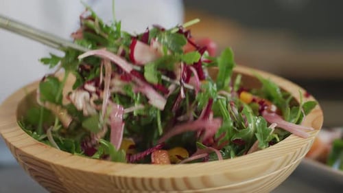 Tossing a Fresh Salad in Bowl Baker