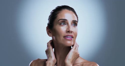 Skincare, spotlight or mature woman in studio with results, radiance or smooth skin in antiaging