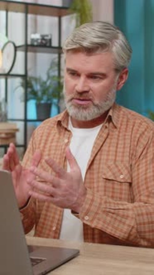 Man Talking During Video Conference in Home Office