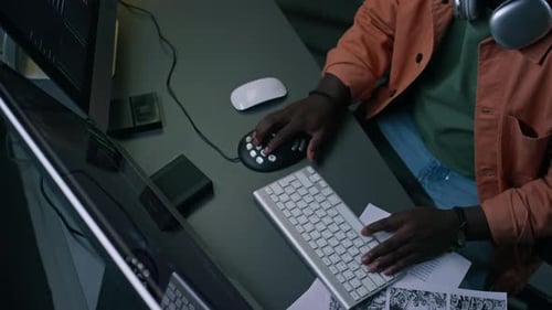 Top View of Postproduction Editor Working on Video Clip