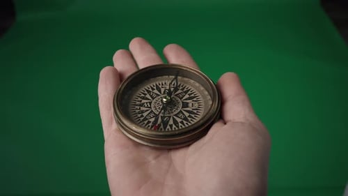 A Rapidly Spinning Compass Arrow Slows Down and Stops Pointing North Compass in an Open Male Palm on