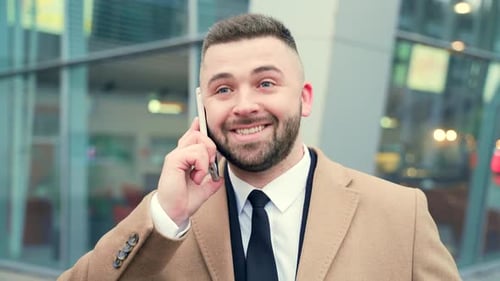 portrait of happy business man talking on mobile phone or smartphone. Face close up of handsome male