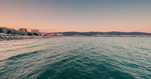 BEAUTIFUL BLACK sea sunset waves WITH CLEAR SKY ORANGE AND TEAL SUNNY BEACH